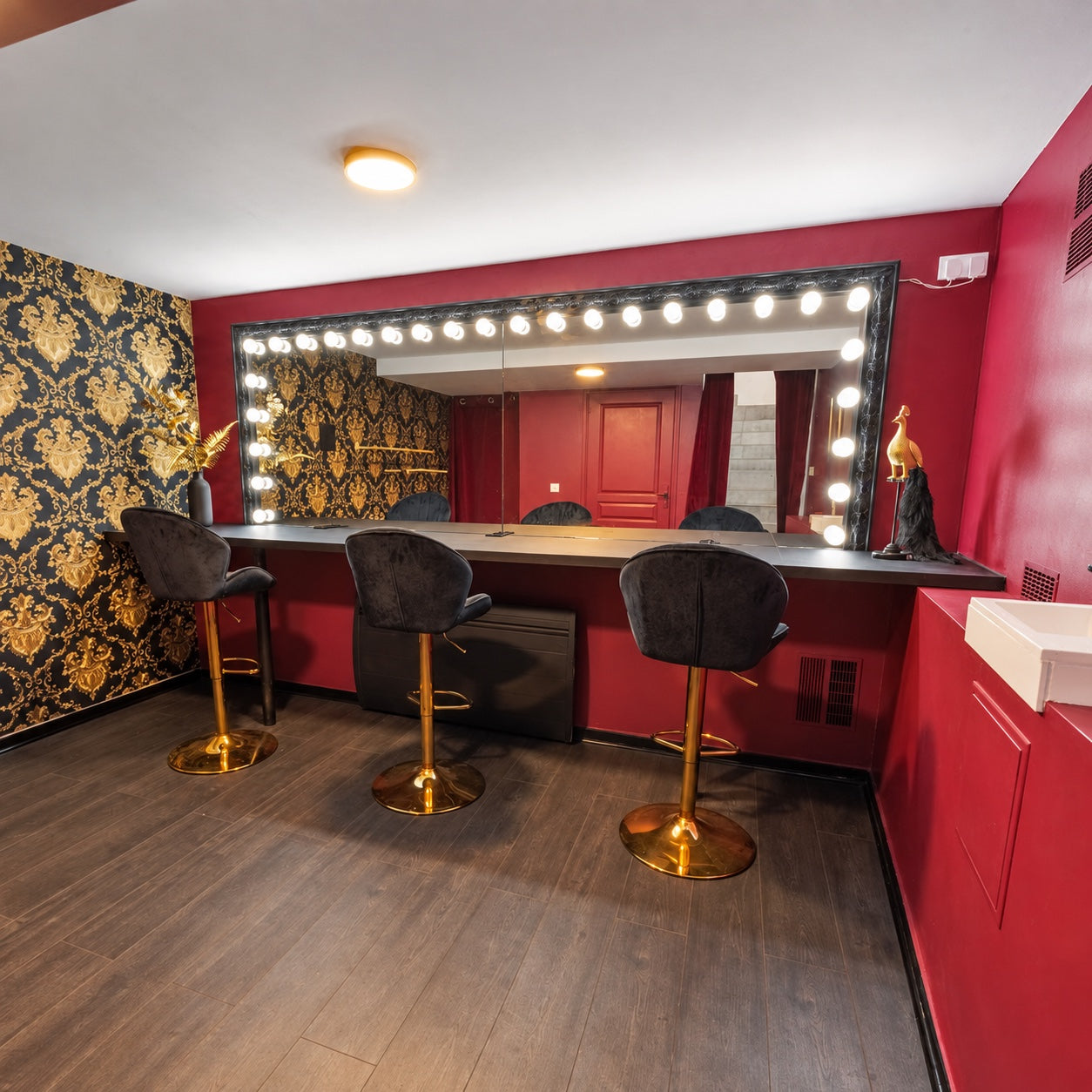 La loge du Studio T7, ses murs bordeaux et son miroir